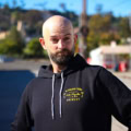 Man in black highland park brewery pullover with fresh los angeles lager artwork