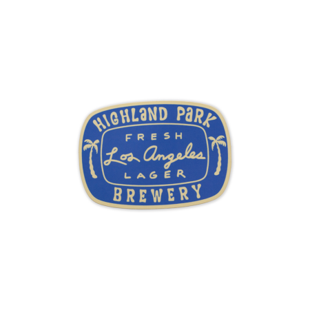 Blue oval sticker with cream colored text, Highland Park Brewery Fresh Los Angeles Lager text and two small palm trees on the sticker.