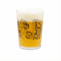 A Forever Grateful Maxi Tumbler filled with hazy golden beer and a foamy head, featuring black illustrations like a grim reaper, a sun figure, and the text "Lachland Fresh Lager Brewery.