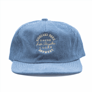 The Fresh Los Angeles Lager Hat - Blue is a blue corduroy cap featuring "Highland Park Brewery Fresh Lager Los Angeles" embroidered on the front in white and yellow thread.