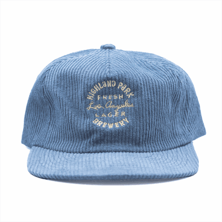 The Fresh Los Angeles Lager Hat - Blue is a blue corduroy cap featuring "Highland Park Brewery Fresh Lager Los Angeles" embroidered on the front in white and yellow thread.