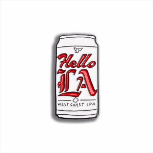 The Hello LA Enamel Pin (2025) is beer can-shaped, featuring "Hello LA" in bold red script and "West Coast IPA" in small black text on a white background.