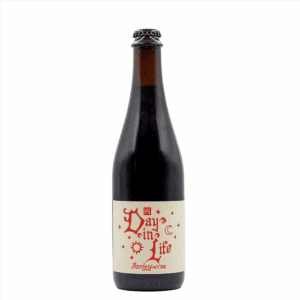 A dark brown glass beer bottle with a cream label that reads "Day in Life Barleywine" in red decorative lettering, from Highland Park Brewery’s Bottle Friends Beer Bottle and Can Releases, stands upright against a plain white background.