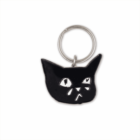 The Sad Cat Enamel Keychain features a black cat's face with wide, sad eyes and a tiny teardrop, attached to a simple silver keyring.