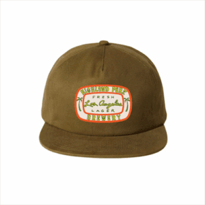 The Fresh Los Angeles Lager Patch Baseball Hat is a brown cap featuring a colorful front patch with "Highland Park Brewery Fresh Los Angeles Lager" and small palm tree illustrations.
