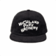 The Highland Park Brewery Corduroy Hat is a black cap featuring bold, white, playful "Highland Park Brewery" lettering on the front, shown on a plain white background.