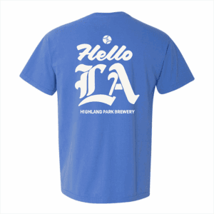The Hello LA Pocket Tee is a blue t-shirt featuring large decorative white "Hello LA" text above "Highland Park Brewery" on the back.