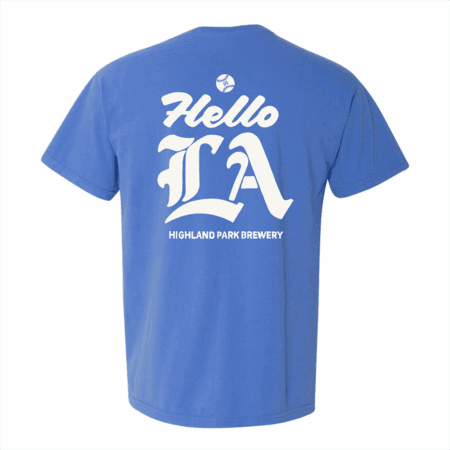The Hello LA Pocket Tee is a blue t-shirt featuring large decorative white "Hello LA" text above "Highland Park Brewery" on the back.