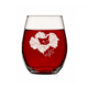 A set of two stemless clear wine glasses, each with a white floral illustration featuring a cat’s face at the center, filled with red liquid—Sad Cat Stemless Wine Glass (Set of 2).