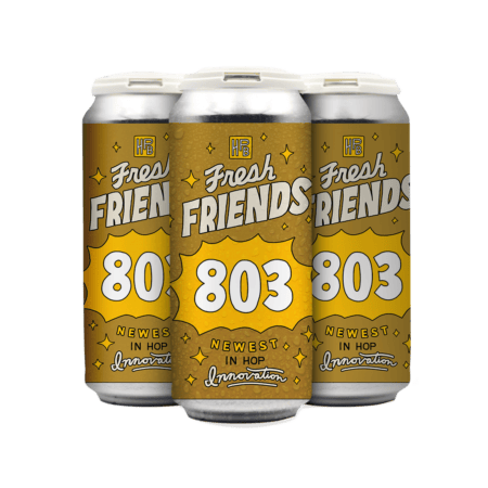 A 4-pack of Fresh Friends: 803 beer, featuring a gold and yellow design with "Newest in Hop Innovation" and decorative stars and sparkles on the cans.