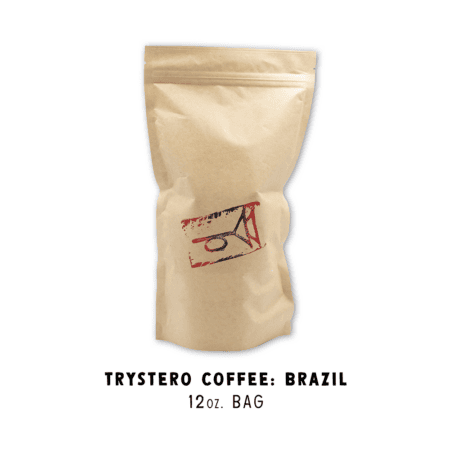 A plain brown coffee bag with a red and black abstract logo. Below, the text reads: “Trystero Coffee: Brazil” on a 12 oz. bag.