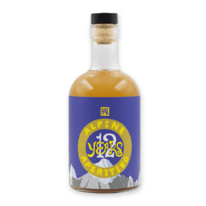 A bottle of 12 Years: Alpine Aperitivo (2026) with a cork stopper, blue and yellow label reading "12 Years" and "Aperitivo," and mountain illustrations at the bottom.