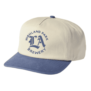 A beige HPB LA baseball cap with a blue brim and button, featuring "Highland Park Brewery LA" in blue on the front.