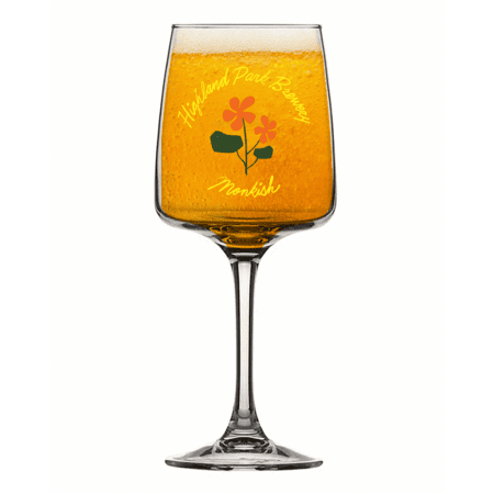A glass of golden beer in a stemmed HPBxMon Tumbler features the text "Highland Park Brewery Monkish" and two orange flowers with green leaves on the front.