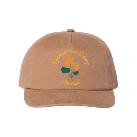 A tan baseball cap featuring yellow and green floral artwork with the words "Highland Park Brewery" and "Monkish" embroidered on the front in yellow and green text.
