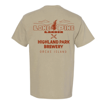 The Lone Pine x HPB Tee is a beige shirt with red text and graphics on the back, showcasing a pine tree, clouds, crossed paddles, and the words “Lone Pine Larder,” “Highland Park Brewery,” and “Orcas Island.”.