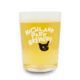 A glass of pale beer with foam on top, served in the Sad Cat Tumbler featuring the words “Highland Park Brewery” and a black cat face printed on the glass.
