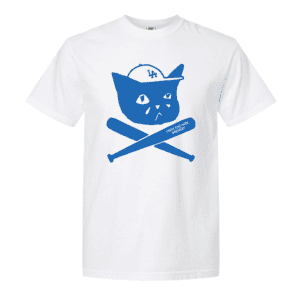 Sad Cat Bats Tee: White t-shirt featuring a blue graphic of a cat wearing a baseball cap with “LA,” sitting above two crossed baseball bats—one labeled “Highland Park Security.”.