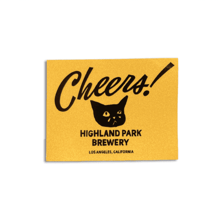 A yellow Fresh LA Lager Holo Sticker featuring black text that reads “Cheers!” above a cat’s face, with “Highland Park Brewery, Los Angeles, California.” printed below.